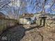 View of backyard with detached garage and wood fence at 1929 Wilcox St, Indianapolis, IN 46222