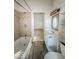 Well-lit full bathroom features a shower-tub, sink, new flooring and toilet at 1929 Wilcox St, Indianapolis, IN 46222