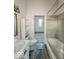 A bathroom with a shower-tub combo, sink, toilet and plenty of storage space at 1929 Wilcox St, Indianapolis, IN 46222