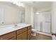 Bathroom featuring wood-look floors, vanity, toilet, large mirror, and tiled shower at 19511 Grassy Branch Rd, Westfield, IN 46074