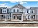 Modern townhomes boast unique color schemes, stone accents and inviting front porches at 19511 Grassy Branch Rd, Westfield, IN 46074