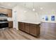 Open floor plan with kitchen island and light wood cabinets leading to the living room at 19511 Grassy Branch Rd, Westfield, IN 46074