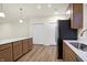 Kitchen featuring an island with white countertops, a stainless steel fridge, and wood cabinets at 19511 Grassy Branch Rd, Westfield, IN 46074
