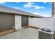 Back patio featuring a concrete pad, vinyl fence, gravel, and access door into home at 19511 Grassy Branch Rd, Westfield, IN 46074