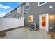 Back patio featuring vinyl fence, door, concrete pad, gravel, and HVAC system at 19511 Grassy Branch Rd, Westfield, IN 46074