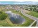 Aerial view of the community with a pond and fountain surrounded by homes at 2150 Aviary Ln, Danville, IN 46122