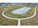 Aerial view of a community pond with fountain and walking path at 2150 Aviary Ln, Danville, IN 46122