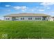 Expansive backyard displays the home's rear exterior under a partly cloudy sky and ample green space at 2150 Aviary Ln, Danville, IN 46122