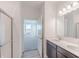 Bathroom with dual sinks, shower, and view of bedroom through open door at 2150 Aviary Ln, Danville, IN 46122