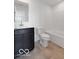 Contemporary bathroom showcases tiled floors, a dark vanity, and a standard toilet and shower tub at 2150 Aviary Ln, Danville, IN 46122