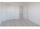 A bedroom with neutral colored carpet, an open door, and sliding door closet at 2150 Aviary Ln, Danville, IN 46122