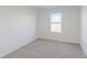 A brightly lit bedroom with neutral carpeting and one double hung window at 2150 Aviary Ln, Danville, IN 46122
