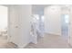Welcoming entryway featuring vinyl floors, carpeted stairs and a convenient powder room at 2150 Aviary Ln, Danville, IN 46122