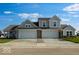 Charming home featuring a three car garage, gray siding, and a well manicured lawn at 2150 Aviary Ln, Danville, IN 46122
