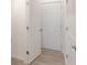 Hallway featuring multiple white doors and wood-look floors at 2150 Aviary Ln, Danville, IN 46122
