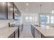 Modern kitchen with granite countertops, island sink, stainless appliances, and lots of natural light at 2150 Aviary Ln, Danville, IN 46122