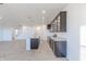 Spacious kitchen featuring gray cabinets, granite countertops, island, and wood-look flooring at 2150 Aviary Ln, Danville, IN 46122