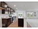 Modern kitchen featuring dark cabinets, stainless appliances, granite countertops and island at 2150 Aviary Ln, Danville, IN 46122