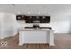 Modern kitchen featuring dark cabinets, granite countertops, and a spacious island at 2150 Aviary Ln, Danville, IN 46122