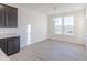 Kitchen with gray cabinets, granite countertops, wood floors, and natural light from large windows at 2150 Aviary Ln, Danville, IN 46122