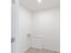 A bright laundry room with utility connections and luxury vinyl plank flooring at 2150 Aviary Ln, Danville, IN 46122