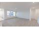 Bright living room featuring light gray wood floors and large windows offering natural light at 2150 Aviary Ln, Danville, IN 46122