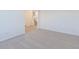 Spacious living room with carpeted floors and a glimpse of the staircase at 2150 Aviary Ln, Danville, IN 46122