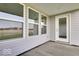 Covered patio features a gray siding and showcases views of the outdoors through adjacent windows at 2150 Aviary Ln, Danville, IN 46122