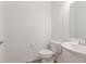 Neat powder room with pedestal sink, toilet, and neutral color scheme at 2150 Aviary Ln, Danville, IN 46122
