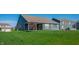 Spacious backyard featuring a lush lawn and a charming covered patio area for outdoor enjoyment at 2349 S Copperstone Dr, New Palestine, IN 46163