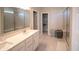 Bright bathroom featuring double vanity, quartz countertop and tiled shower with glass door at 2349 S Copperstone Dr, New Palestine, IN 46163