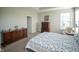 Comfortable bedroom with wood dresser, carpet floors, and warm light from a bedside table at 2349 S Copperstone Dr, New Palestine, IN 46163