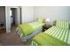 Bright bedroom with twin beds, side table, and a lamp at 2349 S Copperstone Dr, New Palestine, IN 46163