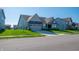 Inviting single-story home featuring a covered entryway, green lawn, and grey two-car garage at 2349 S Copperstone Dr, New Palestine, IN 46163