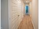 Hallway with wood floors and white doors leading to bedrooms at 2349 S Copperstone Dr, New Palestine, IN 46163