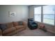 Comfortable living room features a cozy couch, recliner, carpet flooring, and natural light at 2349 S Copperstone Dr, New Palestine, IN 46163