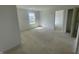 Light-filled bedroom with neutral walls, a window, and an open doorway at 24409 Stout St, Sheridan, IN 46069