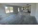 Spacious living room featuring bright windows and an open layout towards the kitchen at 24409 Stout St, Sheridan, IN 46069