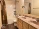 Bathroom featuring a double vanity, bathtub with shower, and wood look flooring at 2549 Black Antler Ct, Indianapolis, IN 46217