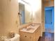 Bathroom featuring a double vanity, large mirror and wood look flooring at 2549 Black Antler Ct, Indianapolis, IN 46217