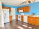 Bright kitchen with wood cabinets, laminate floor, white appliances, and lots of counter space at 2549 Black Antler Ct, Indianapolis, IN 46217