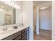 Bathroom boasts double sinks, wood look floors, white walls, and closet view at 275 Hunters Ridge Dr, Danville, IN 46122