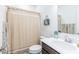 Well-lit bathroom with a neutral shower curtain, white sink, and modern fixtures at 275 Hunters Ridge Dr, Danville, IN 46122