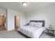 Neutral bedroom with carpet, ensuite bath access, a large window, and an accent table at 275 Hunters Ridge Dr, Danville, IN 46122