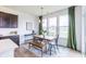 Bright dining area features wood floors, a modern light fixture, and large windows with scenic outdoor views at 275 Hunters Ridge Dr, Danville, IN 46122