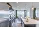 Modern kitchen featuring stainless steel appliances, center island, and a view into the dining area at 275 Hunters Ridge Dr, Danville, IN 46122