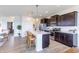 Open kitchen with stainless steel appliances, central island, and seamless access to adjacent living areas at 275 Hunters Ridge Dr, Danville, IN 46122