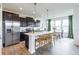 Bright kitchen featuring an island with barstools, stainless appliances, and views into the dining area at 275 Hunters Ridge Dr, Danville, IN 46122