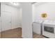 Bright laundry room with modern washer and dryer, with wood-look floors at 275 Hunters Ridge Dr, Danville, IN 46122