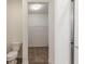 Spacious walk-in closet with custom shelving, carpeting, and a ceiling light at 275 Hunters Ridge Dr, Danville, IN 46122